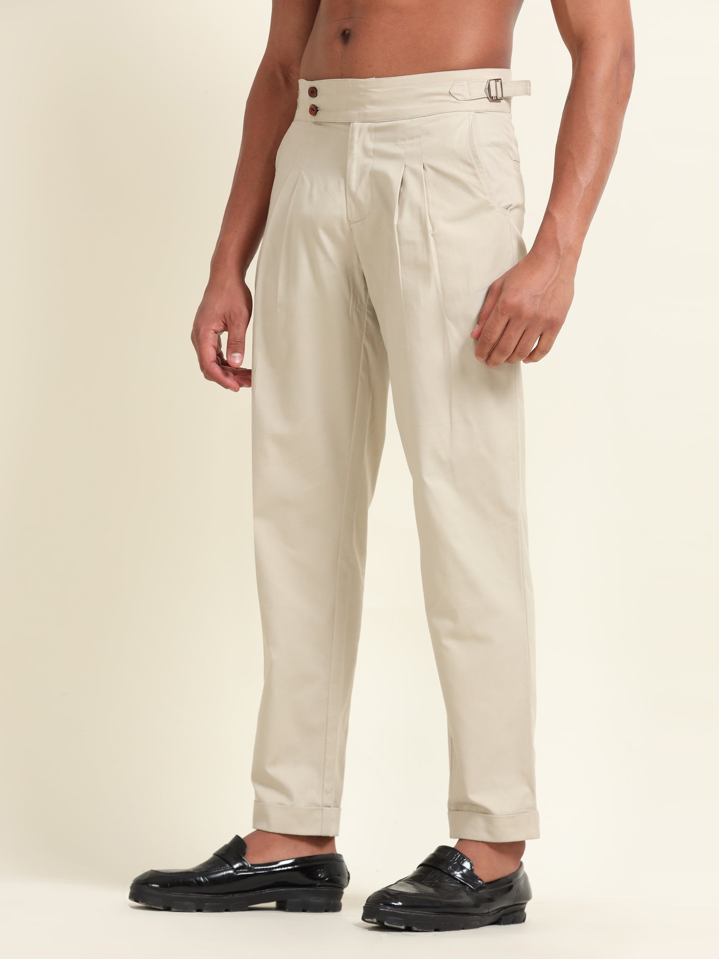 Side view of beige double pleat straight fit pants, emphasizing the structured and polished appearance