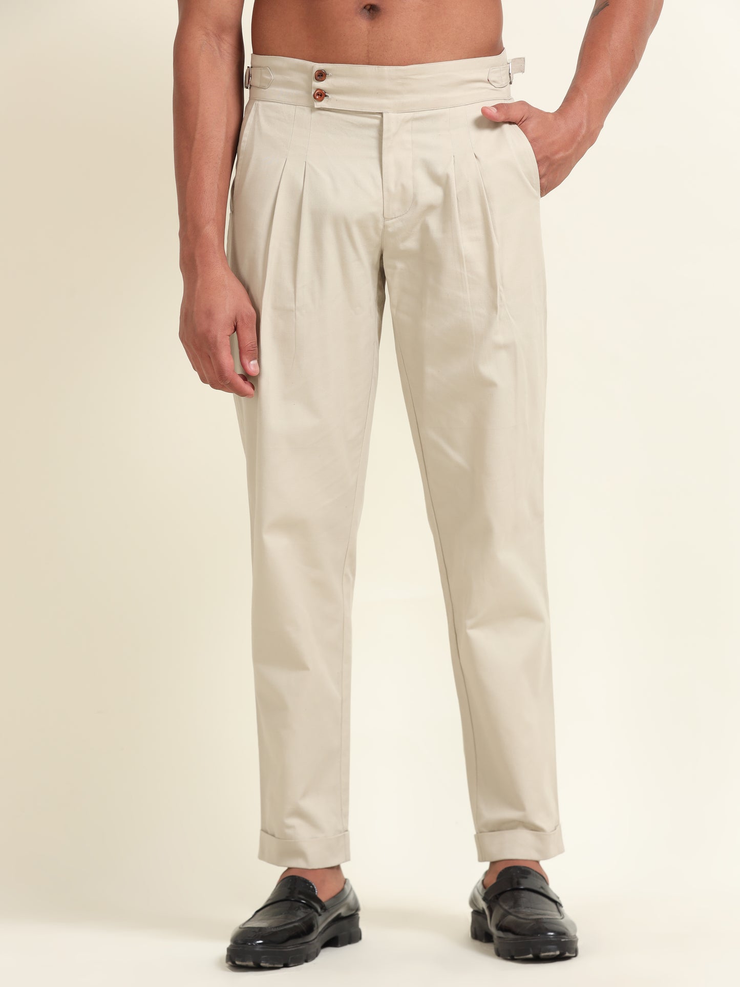 Flat lay of beige double pleat straight fit pants, showing the clean design, pleat details, and high-quality fabric