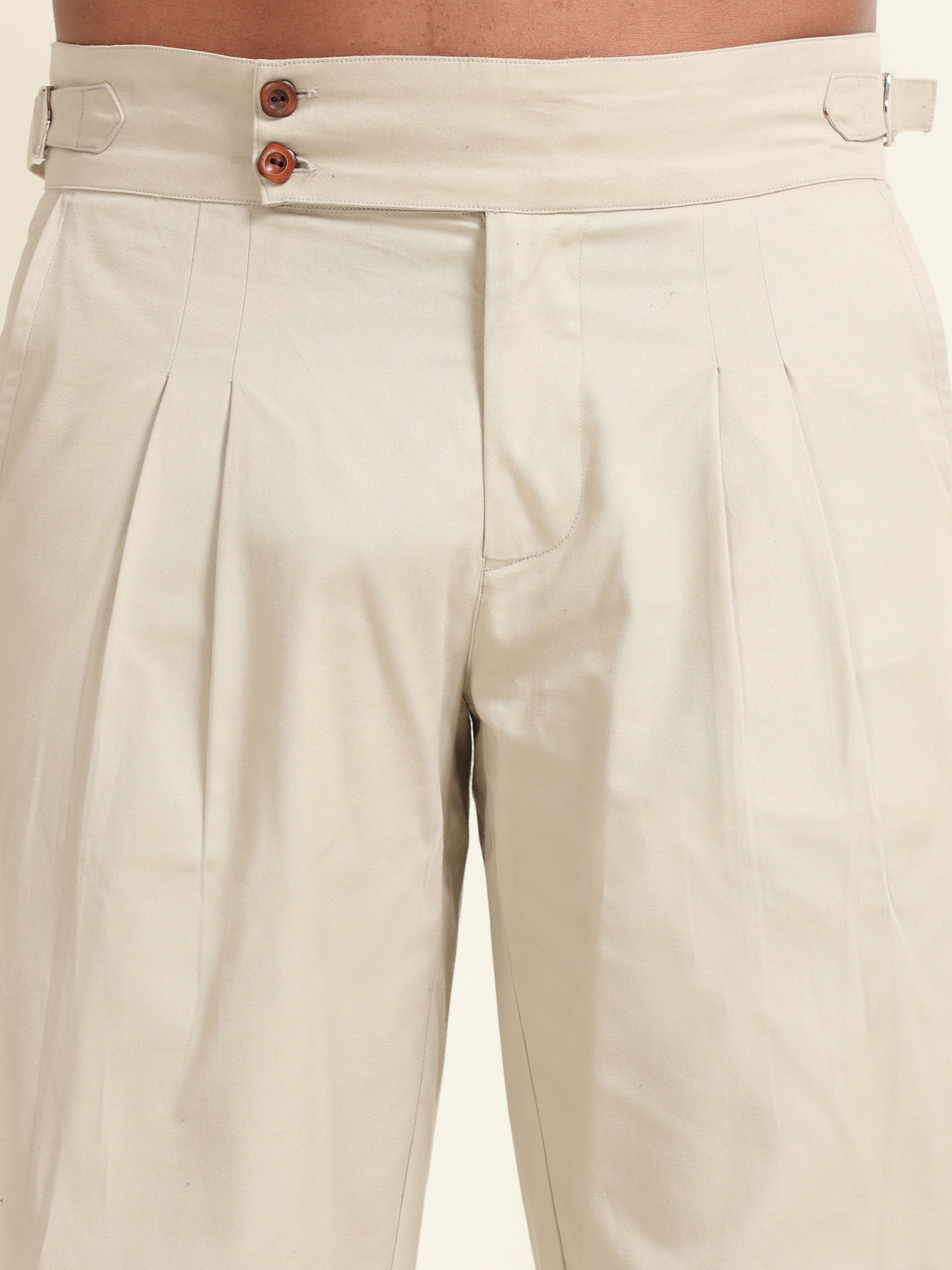 Model wearing beige double pleat straight fit pants, offering a polished look with tailored details and a perfect fit
