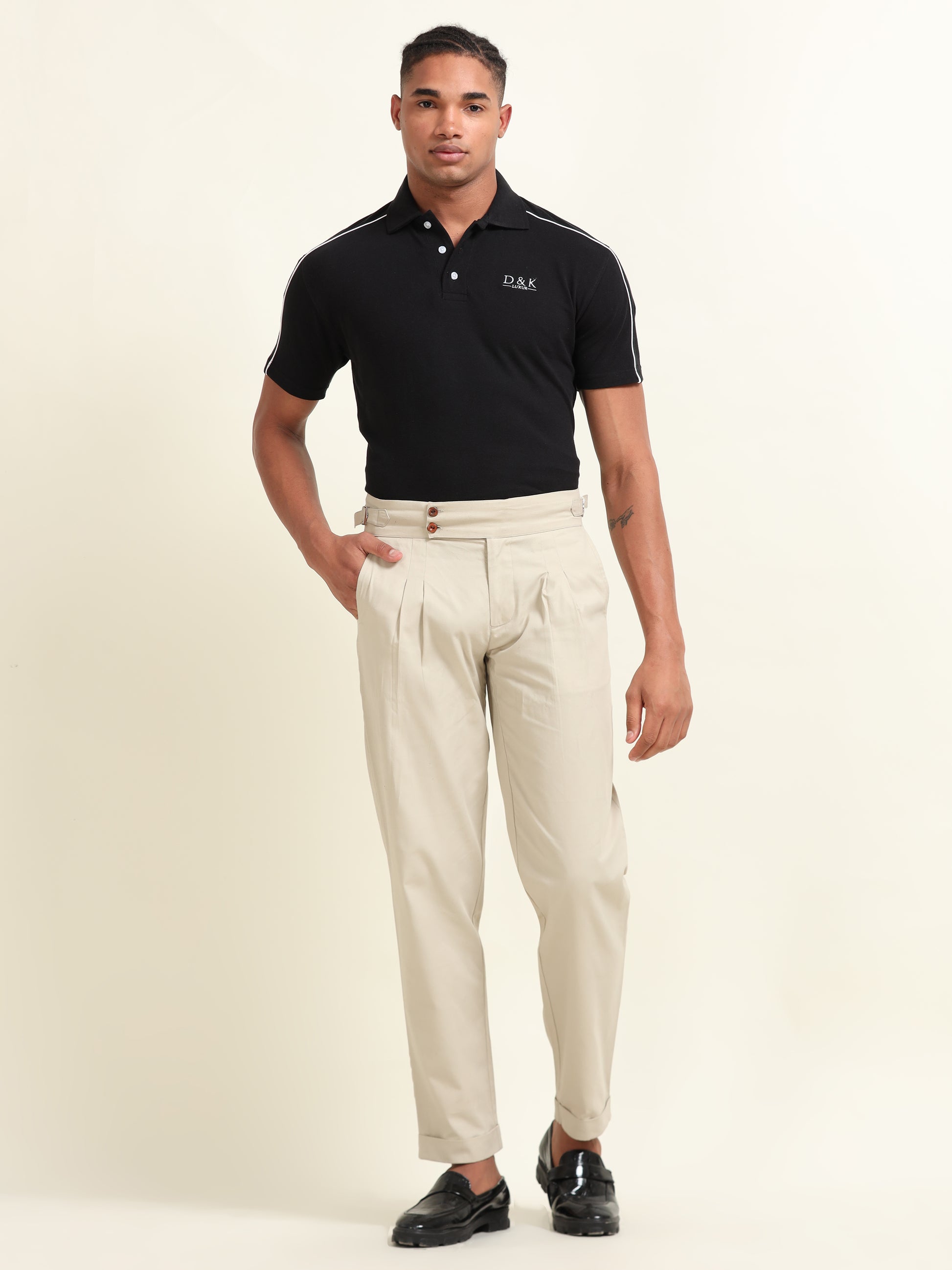 Close-up of side waist belts on beige double pleat straight fit pants, providing an adjustable and custom-tailored fit