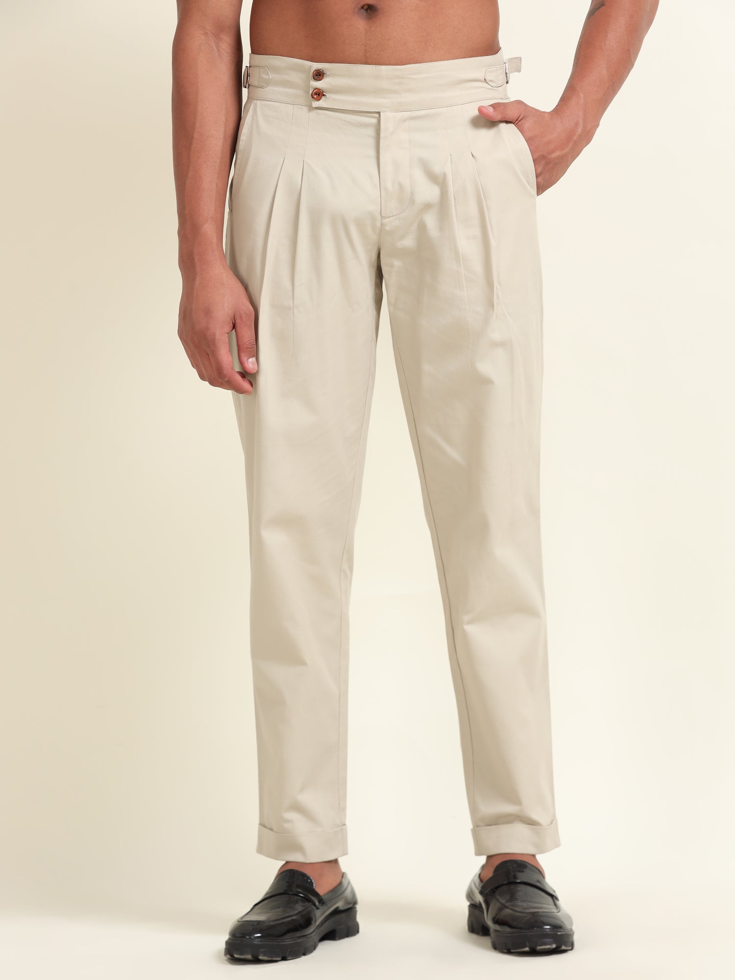 Flat lay of beige double pleat straight fit pants, showing the clean design, pleat details, and high-quality fabric